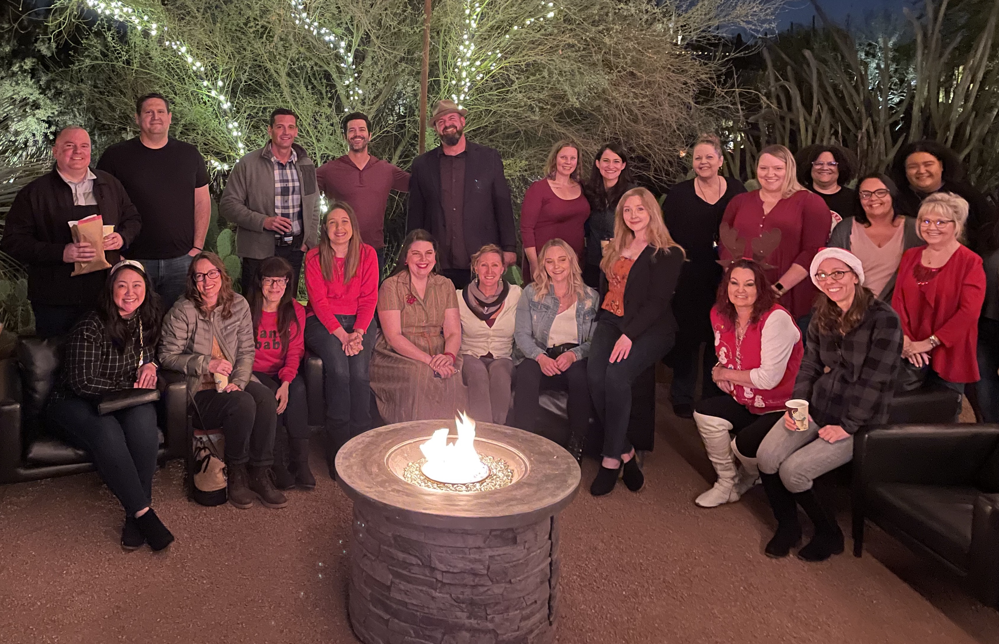 ESI team photo outside around fireplace